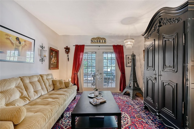 living room featuring french doors and a chandelier