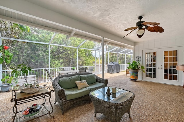 sunroom featuring beam ceiling, french doors, and ceiling fan