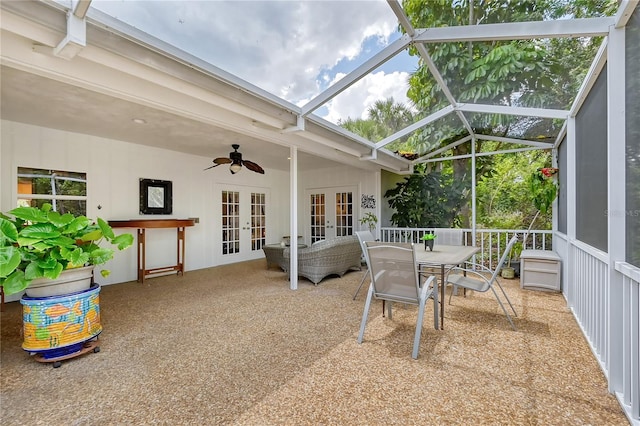 sunroom / solarium featuring lofted ceiling, french doors, and ceiling fan