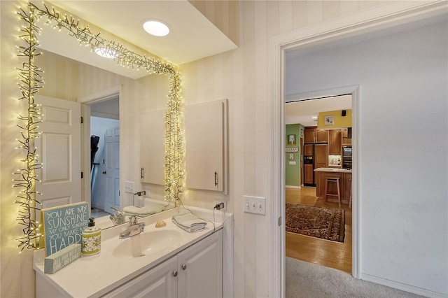 bathroom with vanity and hardwood / wood-style flooring