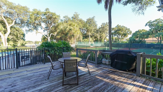 wooden deck featuring a grill