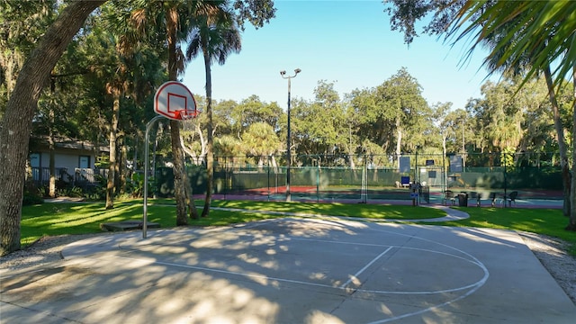 view of basketball court featuring a lawn