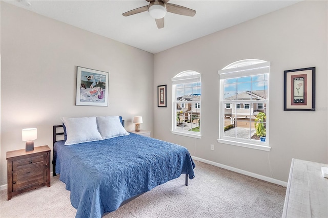 bedroom featuring ceiling fan and light carpet