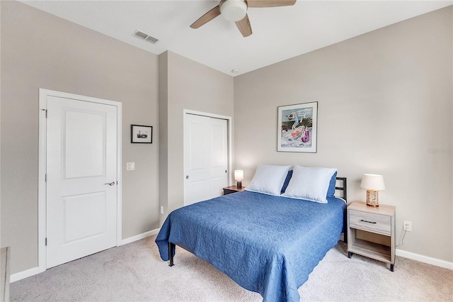 carpeted bedroom featuring a closet and ceiling fan