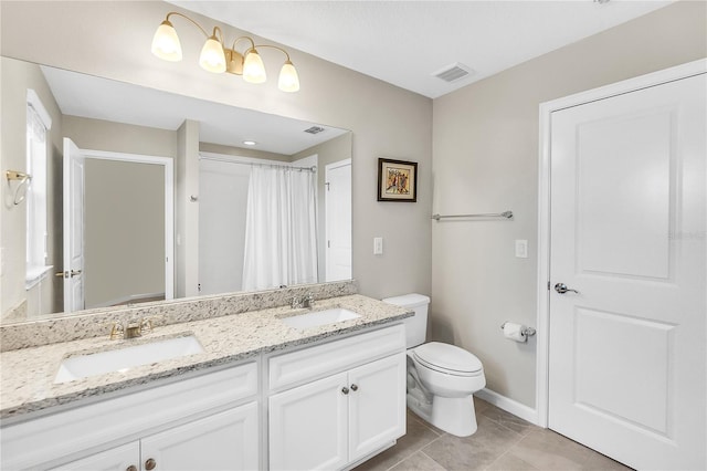 bathroom with vanity, toilet, and tile patterned flooring