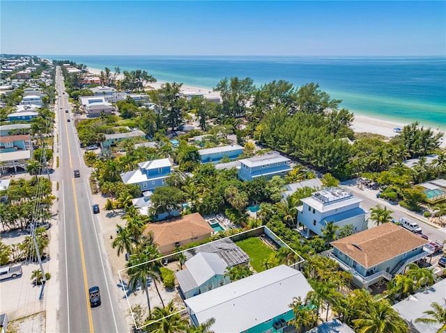 aerial view with a water view and a beach view