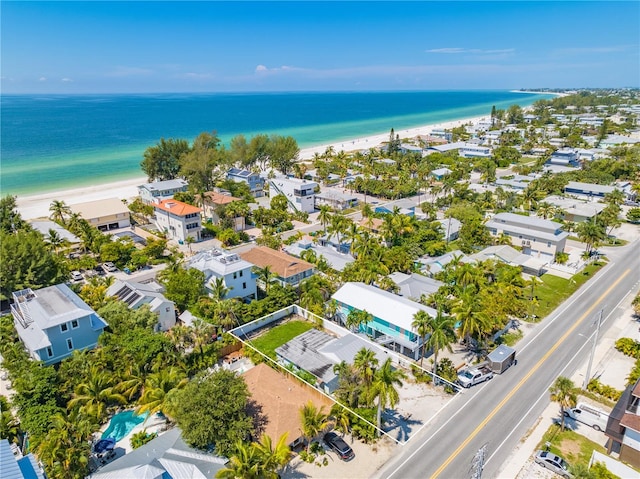 drone / aerial view featuring a water view and a beach view