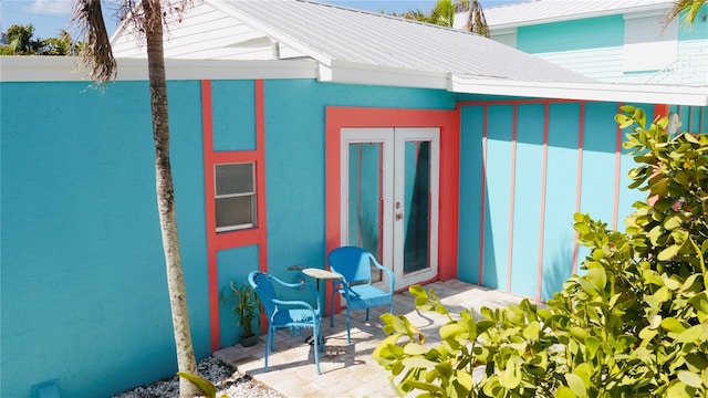 property entrance featuring french doors and a patio area