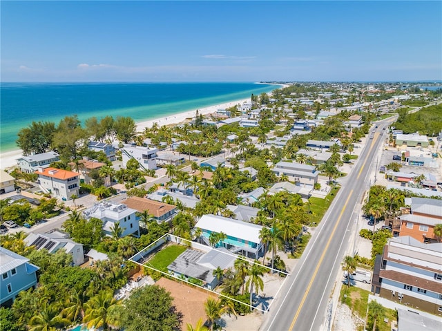 birds eye view of property with a water view and a view of the beach