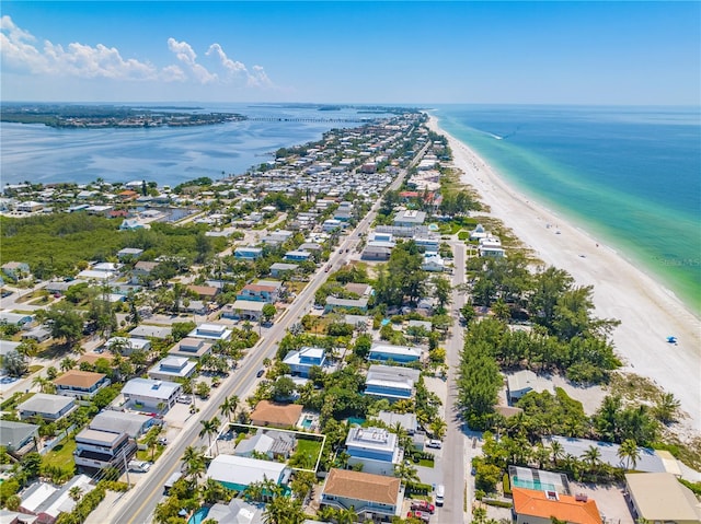 drone / aerial view featuring a water view and a view of the beach