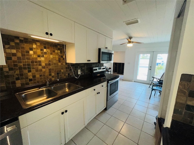 kitchen with decorative backsplash, french doors, sink, white cabinets, and appliances with stainless steel finishes