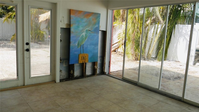 doorway to outside with light tile patterned floors