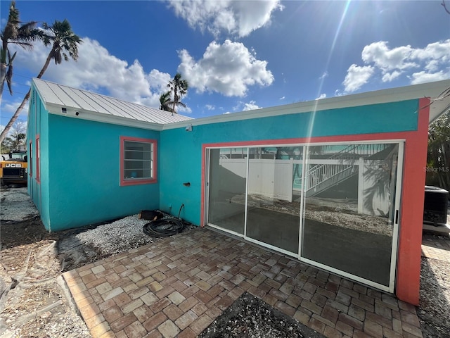 rear view of property with a patio area and cooling unit