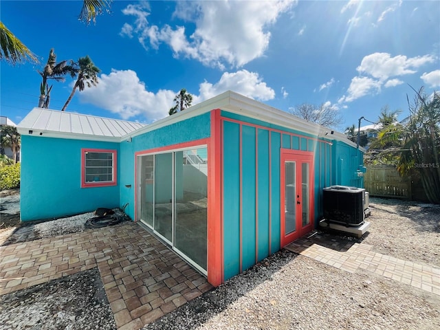 view of outdoor structure featuring french doors and central AC unit