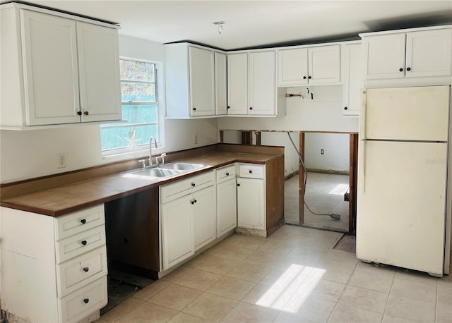 kitchen with white cabinets, white fridge, sink, and dishwasher