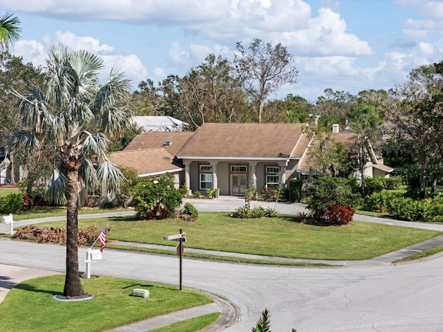 ranch-style house with a front lawn