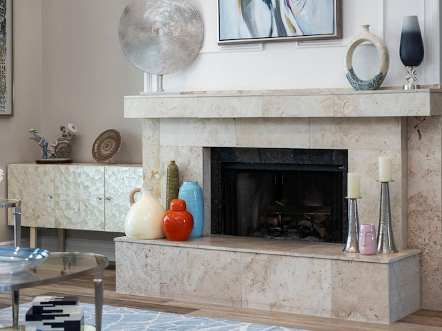 room details featuring a fireplace and wood-type flooring