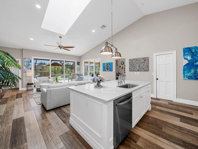 kitchen featuring sink, dishwasher, an island with sink, and dark hardwood / wood-style floors