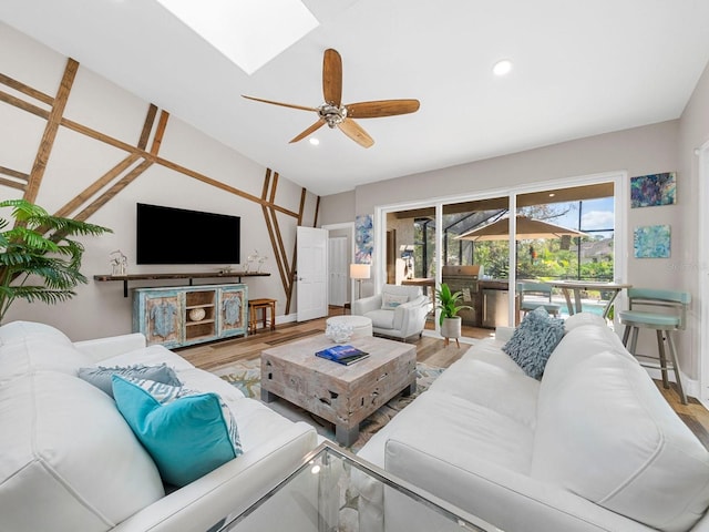 living room featuring hardwood / wood-style floors, vaulted ceiling, and ceiling fan