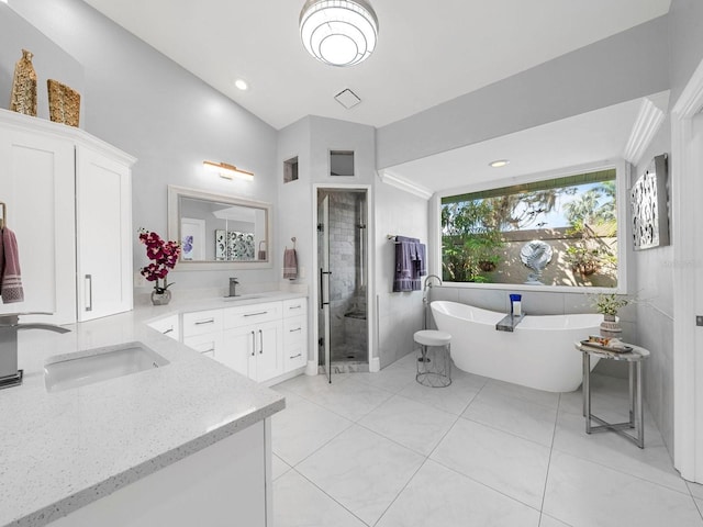 bathroom with vanity, tile patterned floors, lofted ceiling, and shower with separate bathtub