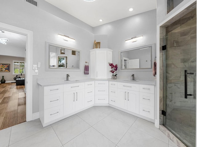 bathroom featuring vanity, wood-type flooring, and a shower with shower door