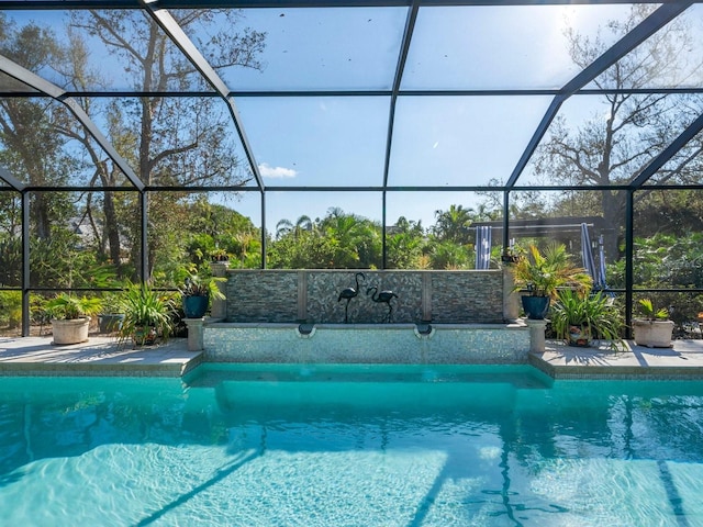 view of swimming pool featuring a patio area and glass enclosure