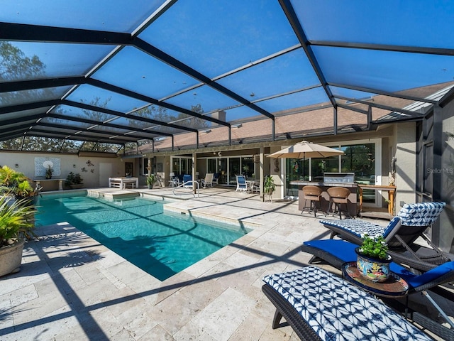 view of swimming pool featuring an outdoor bar, a patio, and glass enclosure