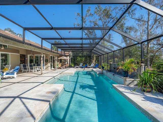 view of swimming pool with a patio and glass enclosure