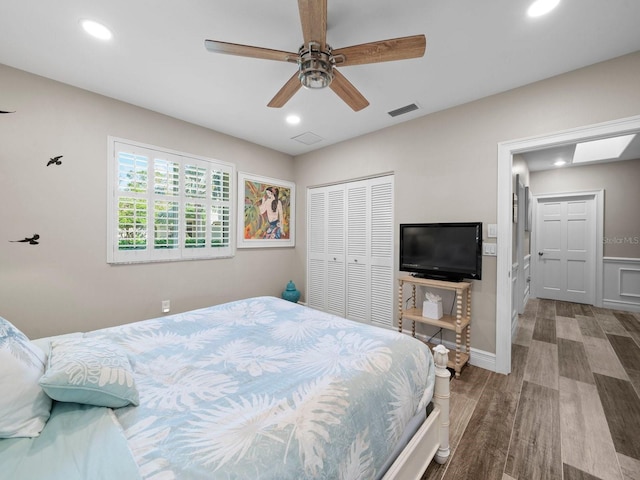 bedroom with a closet, wood-type flooring, and ceiling fan