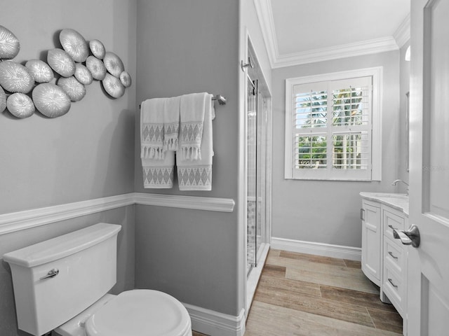 bathroom featuring toilet, wood-type flooring, crown molding, vanity, and walk in shower