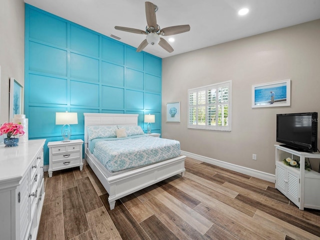 bedroom with hardwood / wood-style floors and ceiling fan