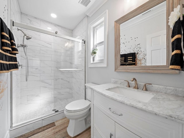 bathroom featuring a shower with door, toilet, wood-type flooring, and vanity