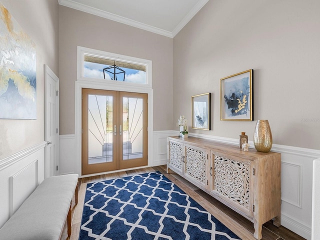 entrance foyer featuring french doors, hardwood / wood-style flooring, a high ceiling, and crown molding