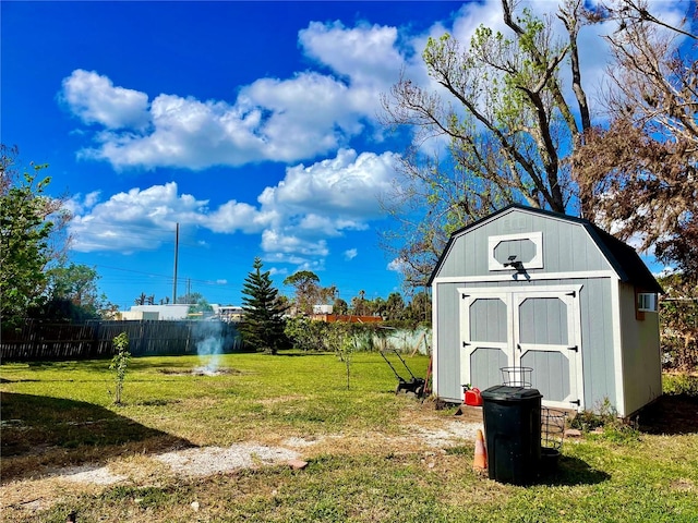 view of yard with a storage shed and a water view