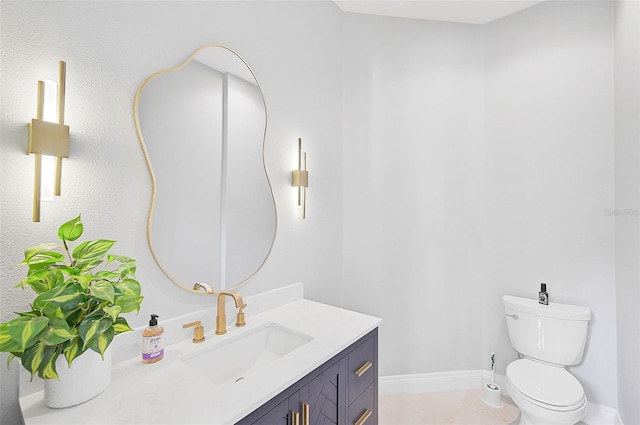 bathroom featuring toilet, vanity, and tile patterned floors