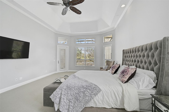 bedroom with carpet, ceiling fan, crown molding, and a tray ceiling