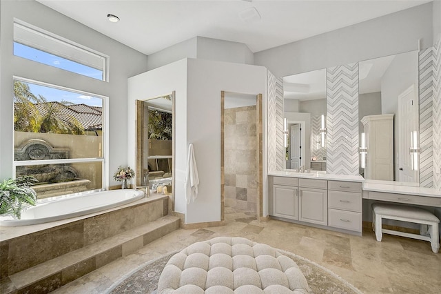 bathroom featuring vanity and separate shower and tub