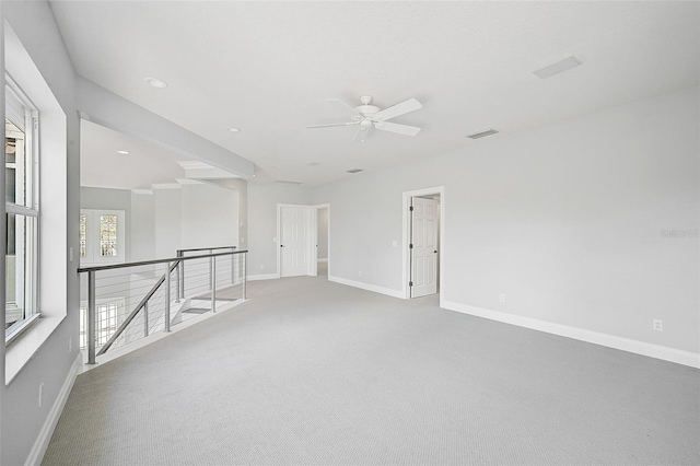 carpeted spare room with ceiling fan