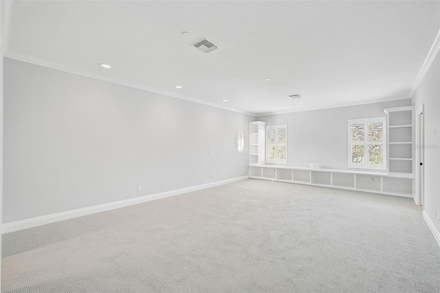 carpeted empty room featuring crown molding