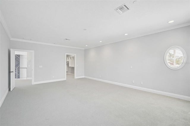 carpeted empty room featuring ornamental molding