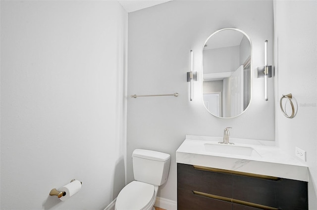 bathroom featuring toilet and vanity