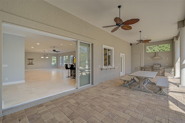 view of patio with area for grilling and ceiling fan