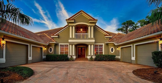 view of front of house featuring a garage and a balcony