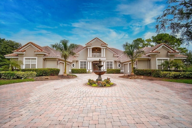 mediterranean / spanish-style house with a garage