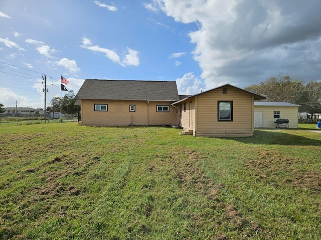 back of house with a lawn