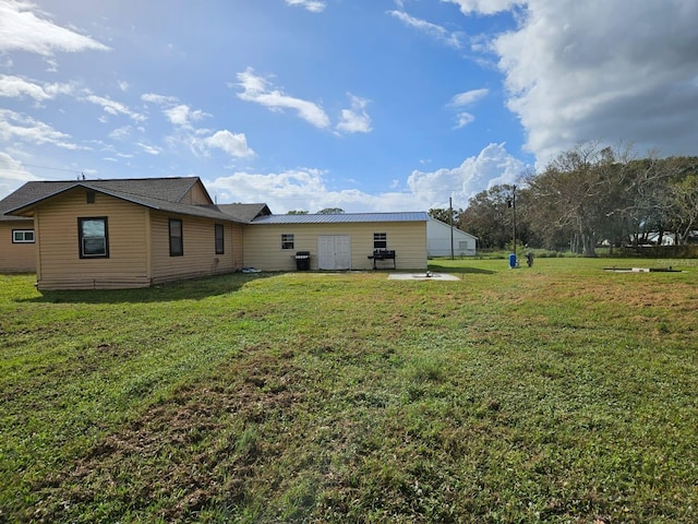 rear view of house with a patio area and a lawn