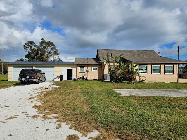 view of front of property featuring cooling unit and a front lawn