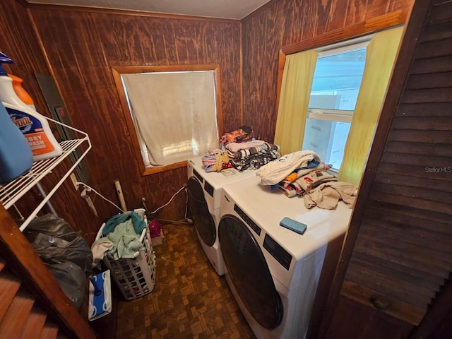 laundry room with wooden walls, dark parquet flooring, and separate washer and dryer