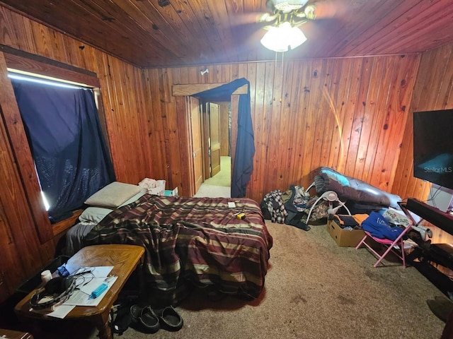 carpeted bedroom featuring wood ceiling and wooden walls