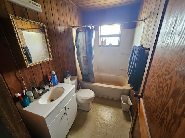 full bathroom featuring vanity, wooden walls, shower / bath combo, and toilet